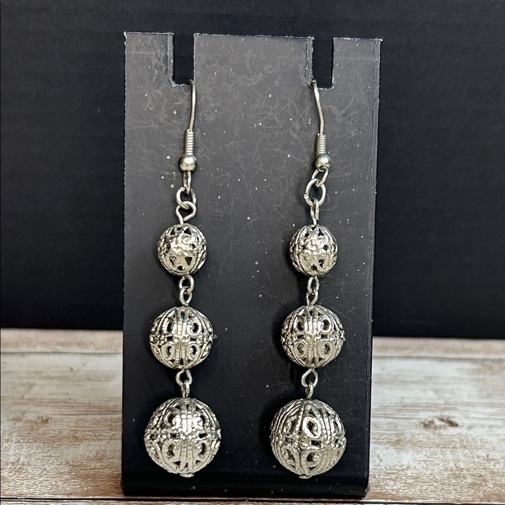 Silver filigree globe dangle earrings